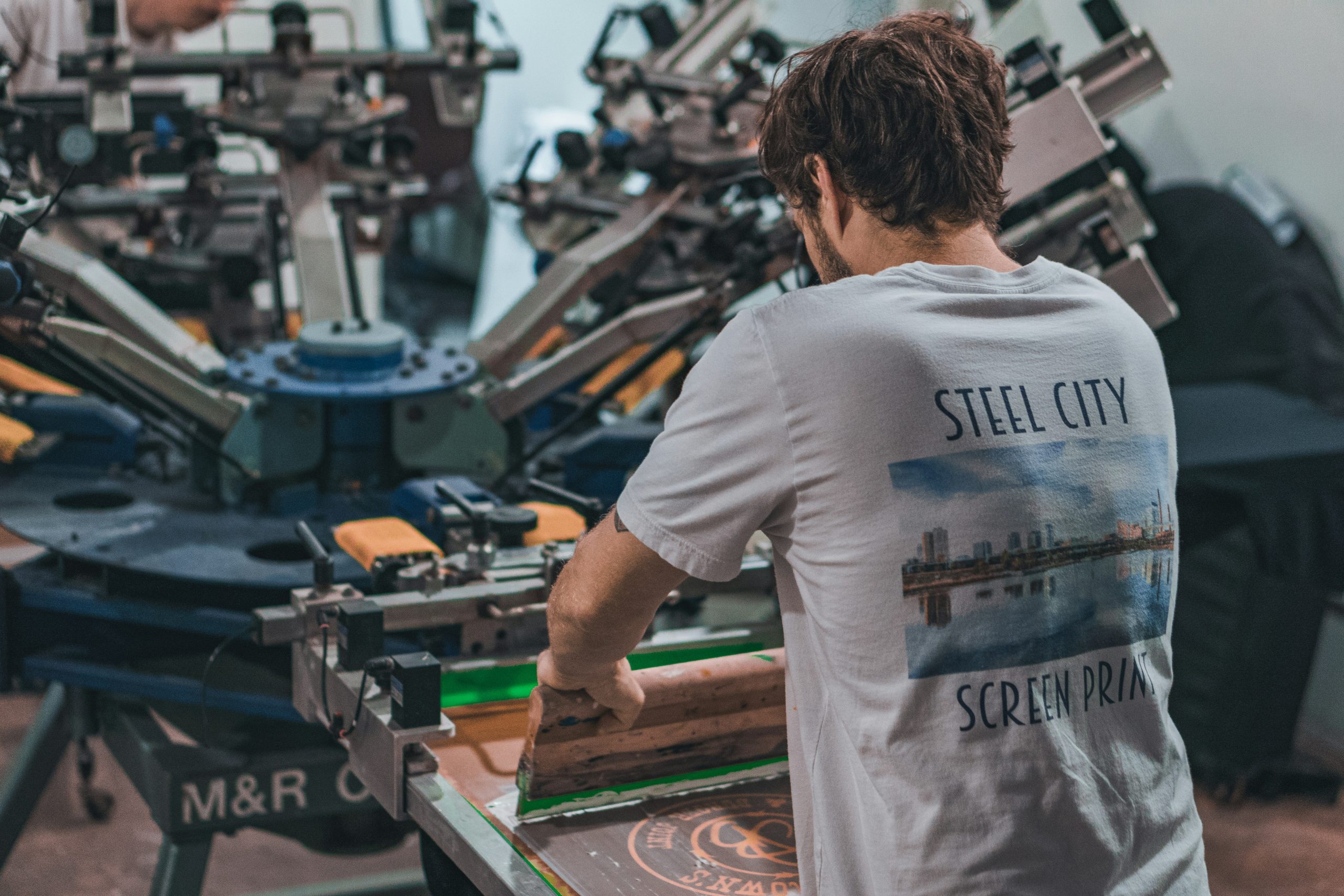 man using a screen printer