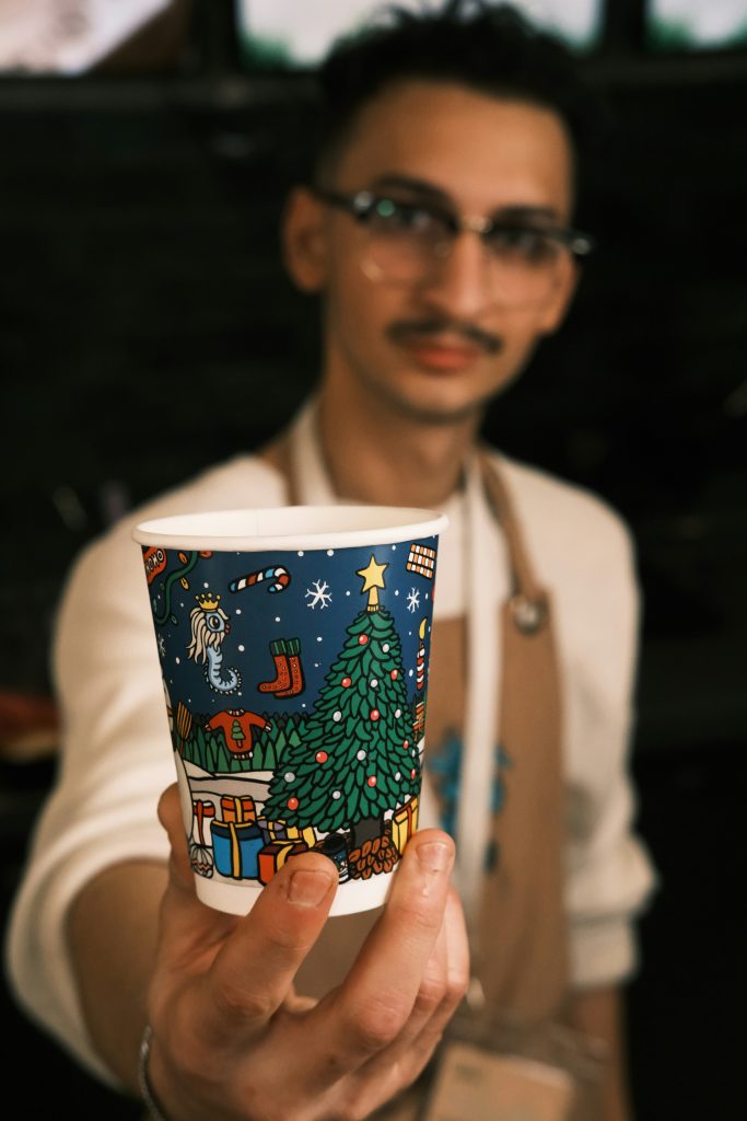 Man with a cup that has a print on it